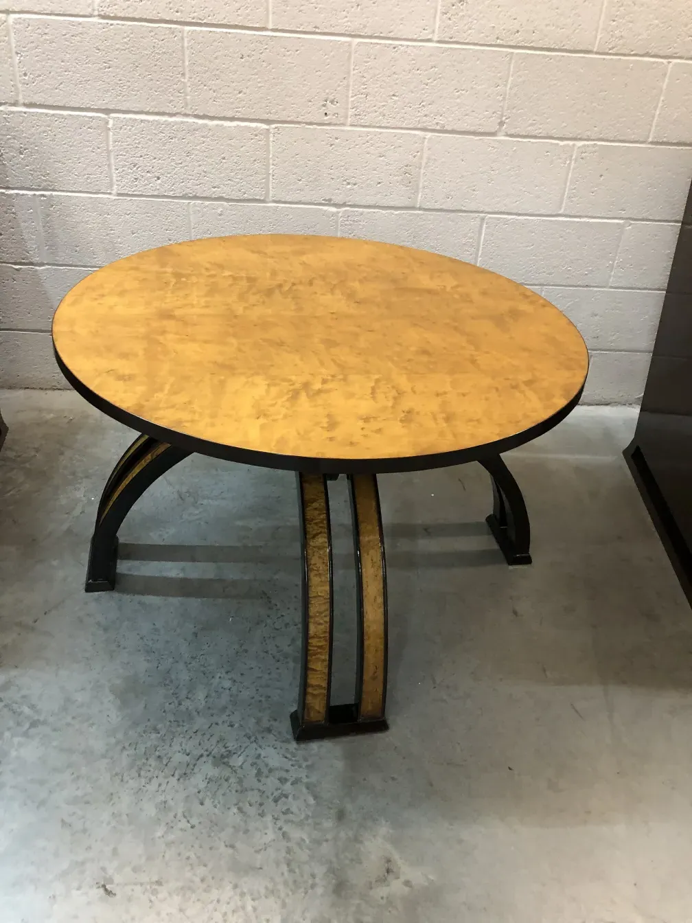 Antique round coffee table with decorative design in a modern setting.