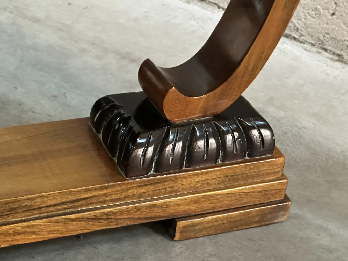 base de table basse antique avec des détails sculptés, dans un cadre neutre