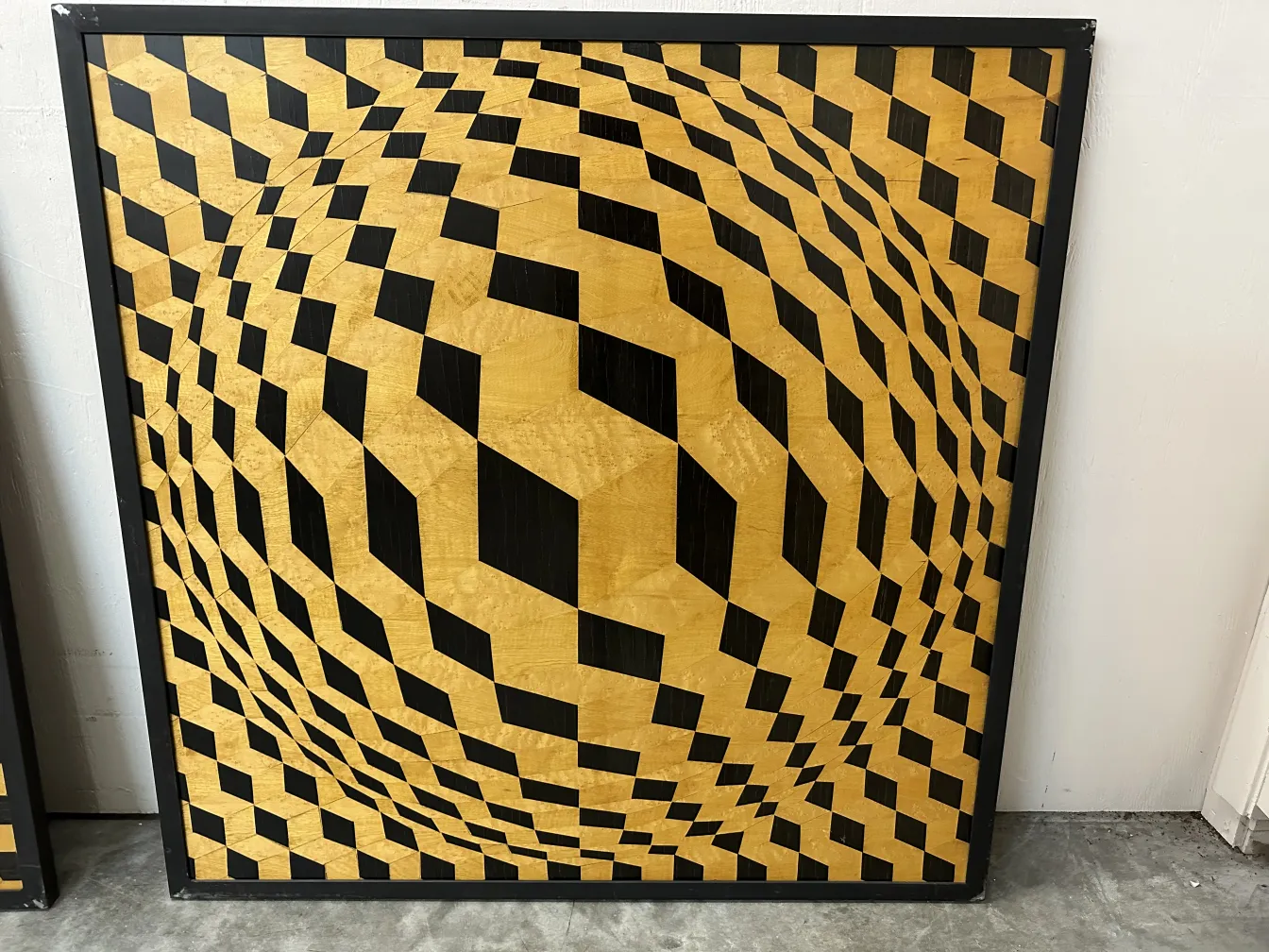 Antique marquetry with golden and black diamond-shaped patterns.