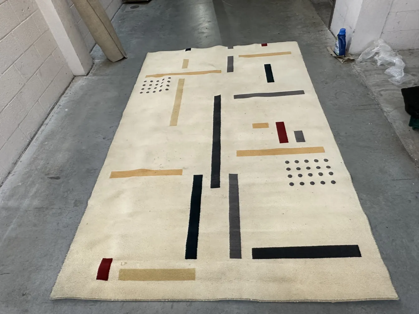 alter Teppich mit hellem Hintergrund und bunten Mustern