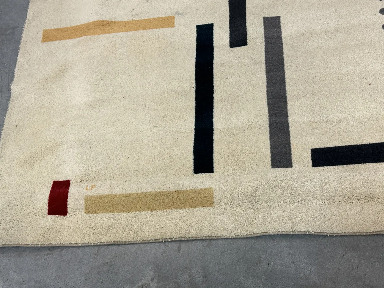 details of an antique carpet with rectangular shapes in soft colors