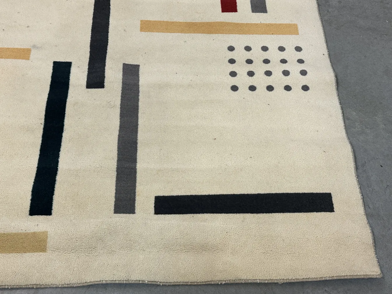 antique carpet with geometric patterns in neutral colors