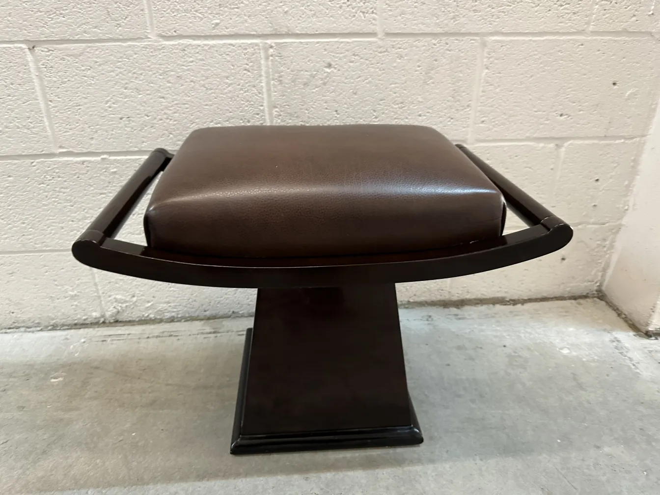 Antique stool with stylish upholstery and elegant design, neutral background.