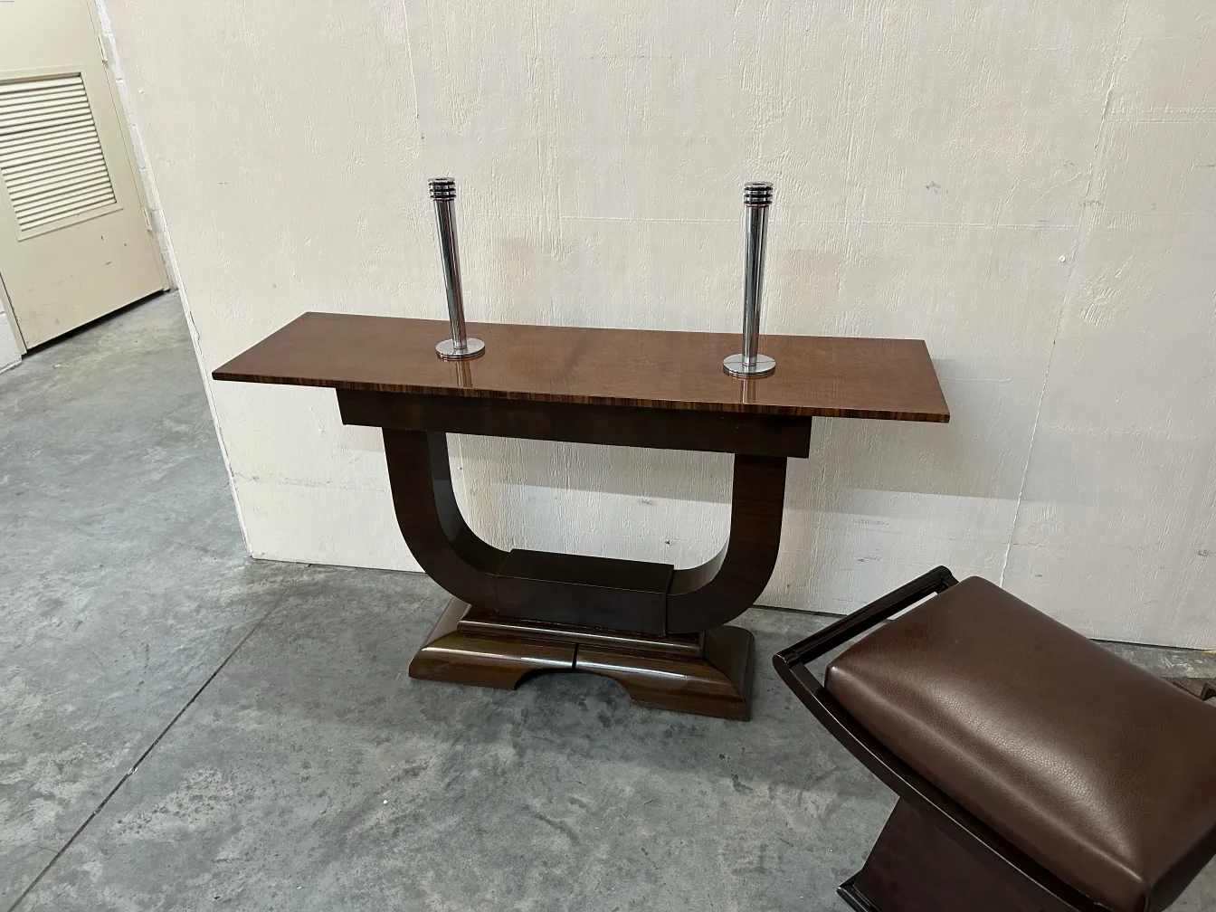 Antique bench with elegant design and curved shape, set in a minimalistic environment.