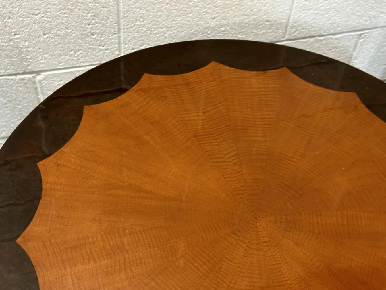 Round antique small table with edge details, neutral setting.