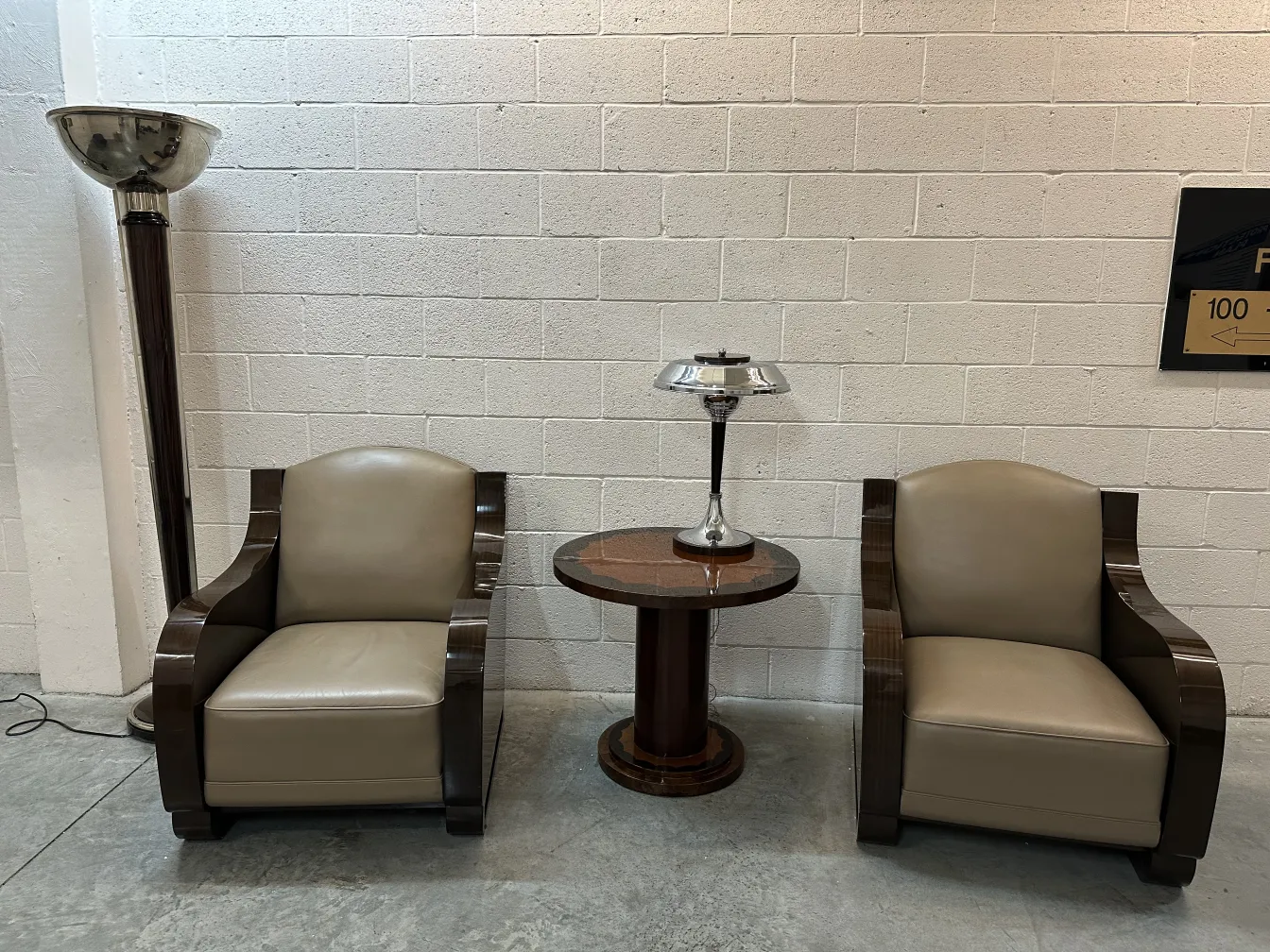 small antique table next to armchairs and lamp