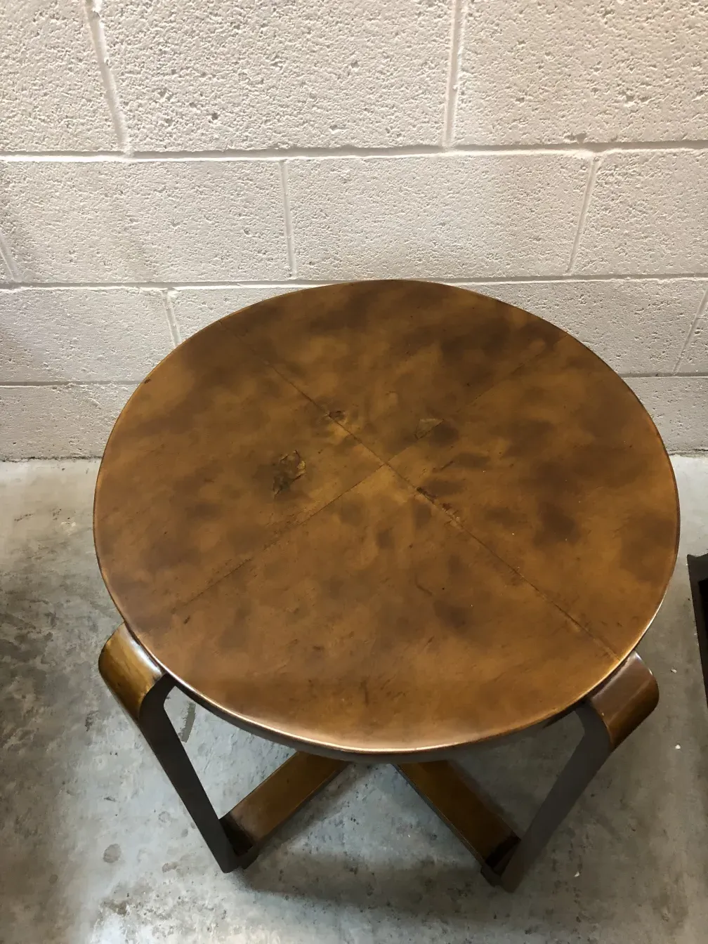 antique round small table with a smooth surface in a simple setting