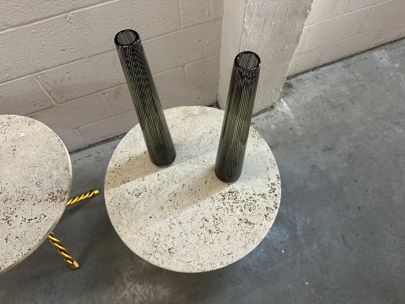 two antique small tables with round design in a modern setting