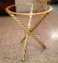 View of two antique small tables with twisted legs, in a modern setting.