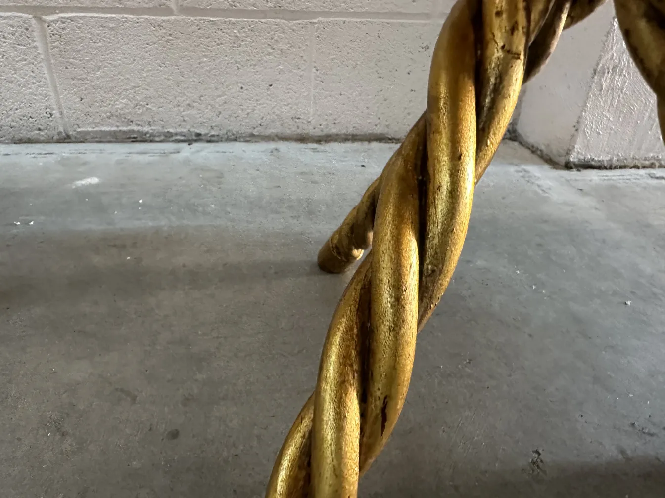 View of twisted golden legs of two antique small tables