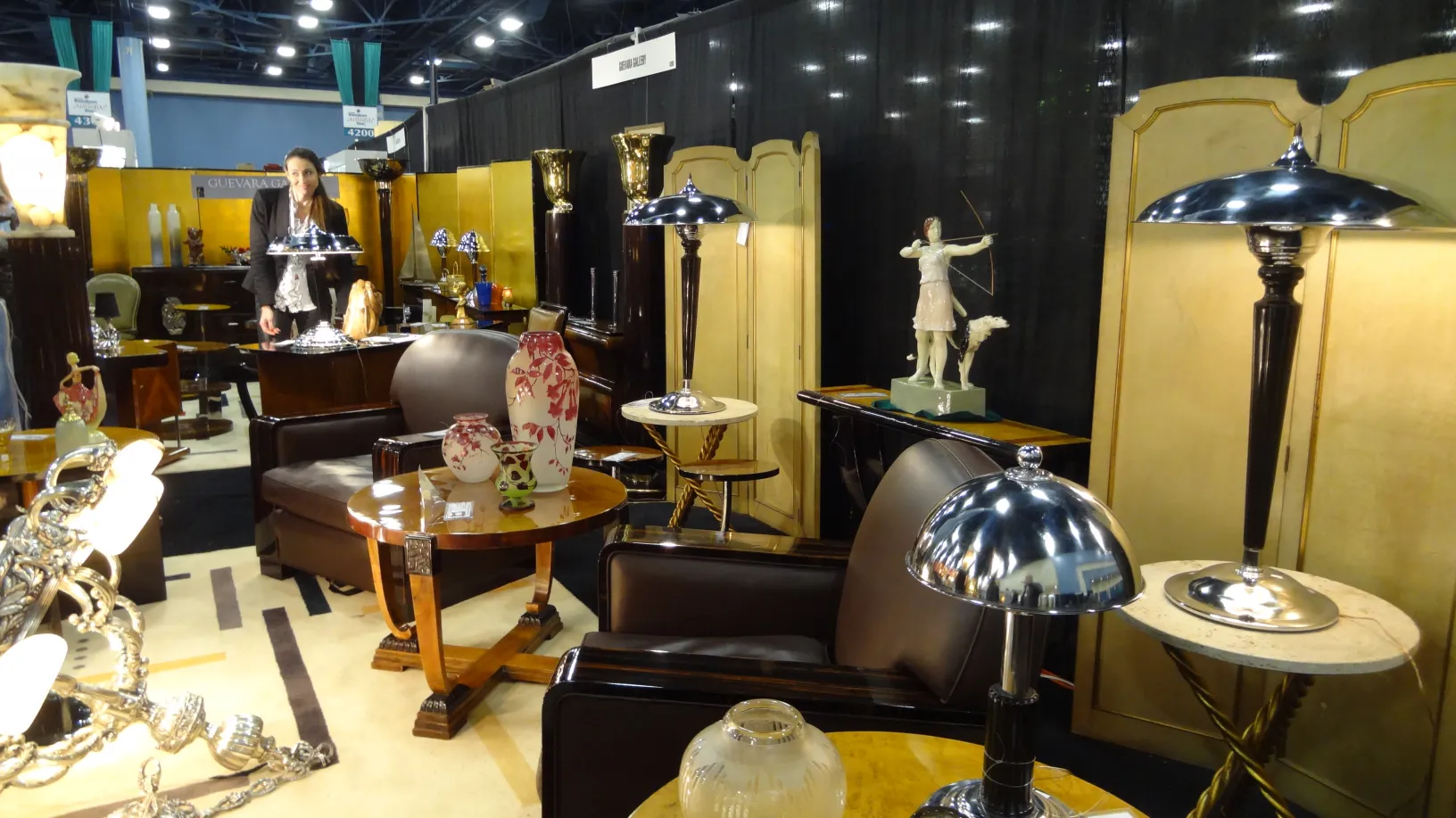 View of 2 antique small tables surrounded by decorative items