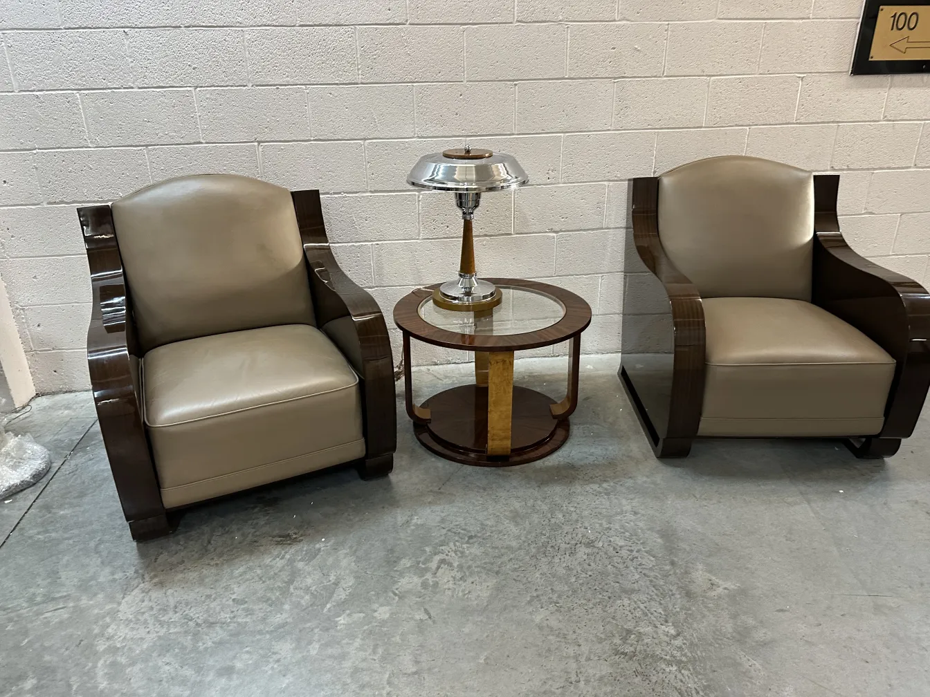 two antique small tables next to elegant chairs in a modern setting