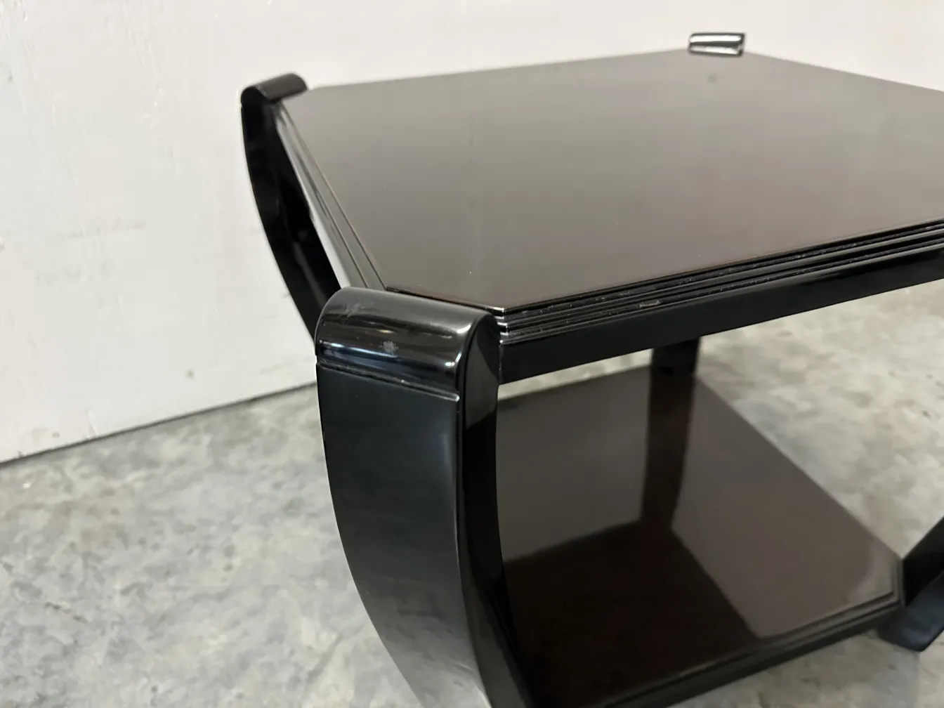 side view of 2 elegant antique small tables in decorative setting