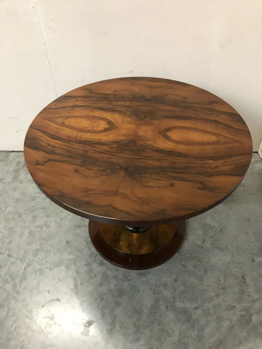 2 antique small tables with oval shape in a neutral setting