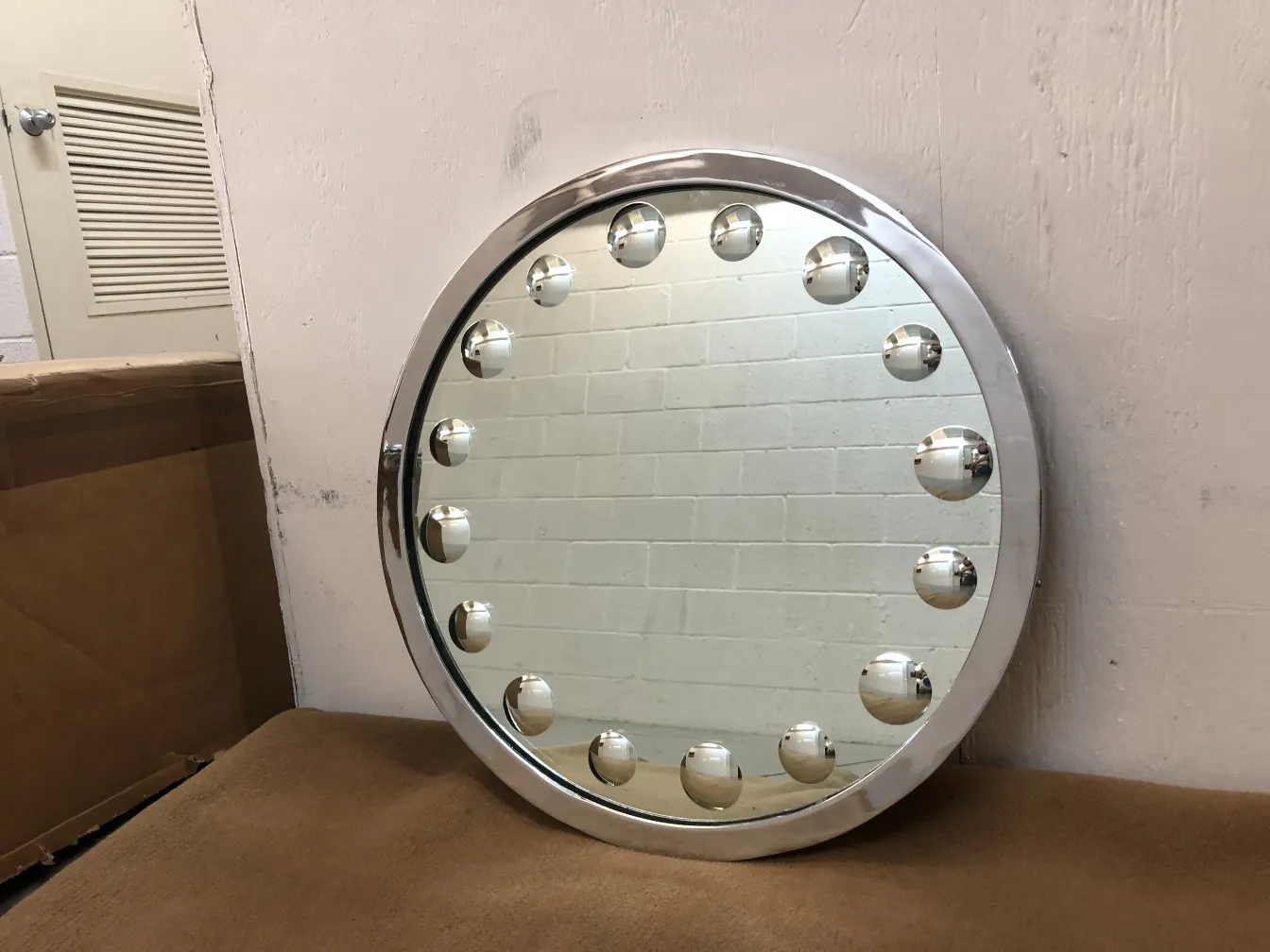round antique mirror with lights and light background