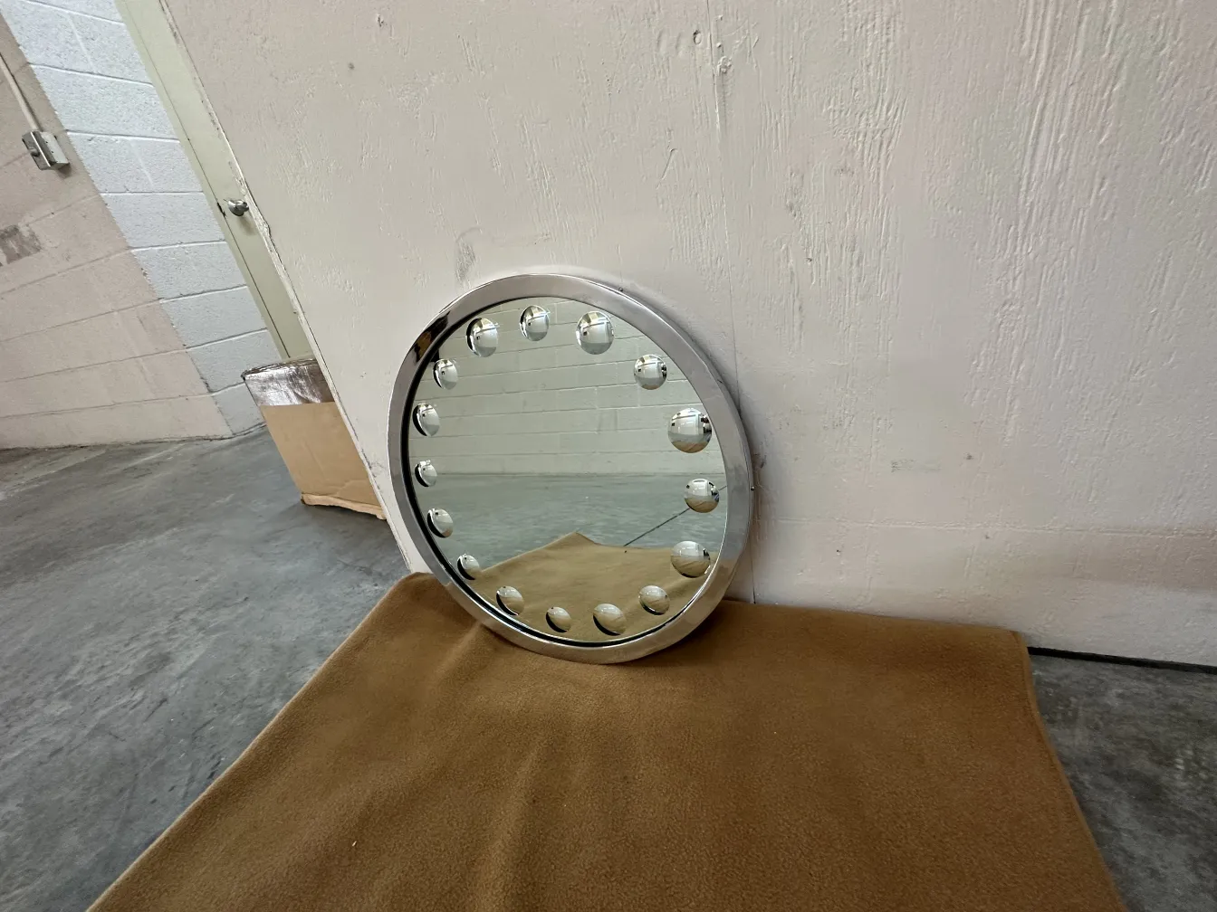 miroir ancien rond avec lumières autour et fond doux