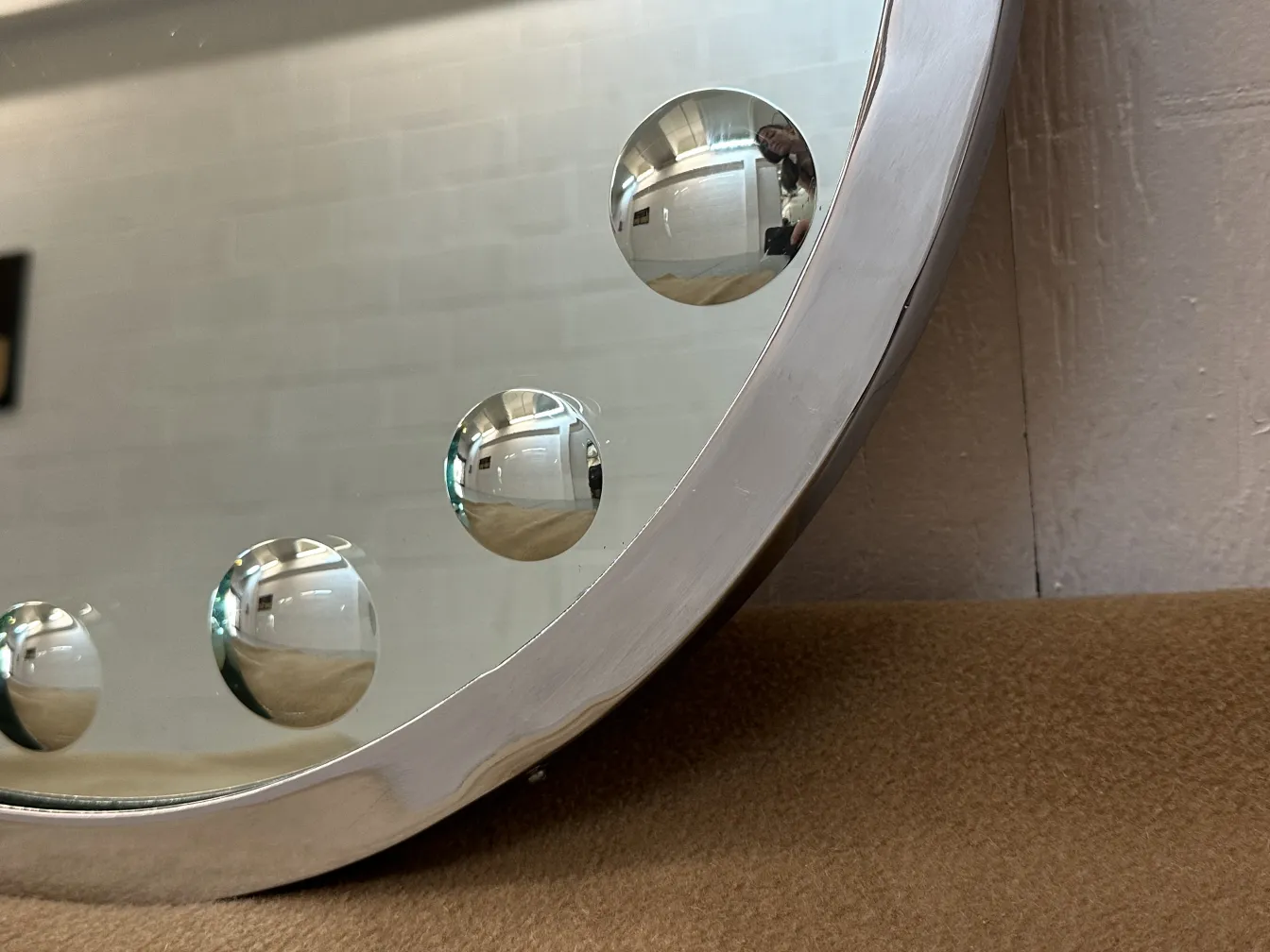 antique mirror featuring decorative spheres in the frame