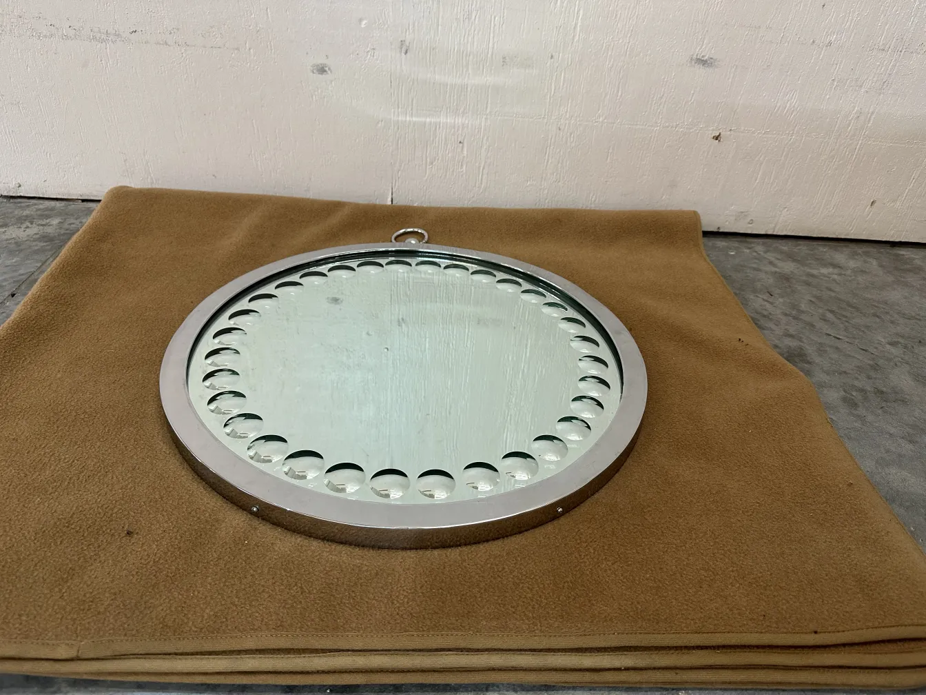 two antique round mirrors on a soft surface
