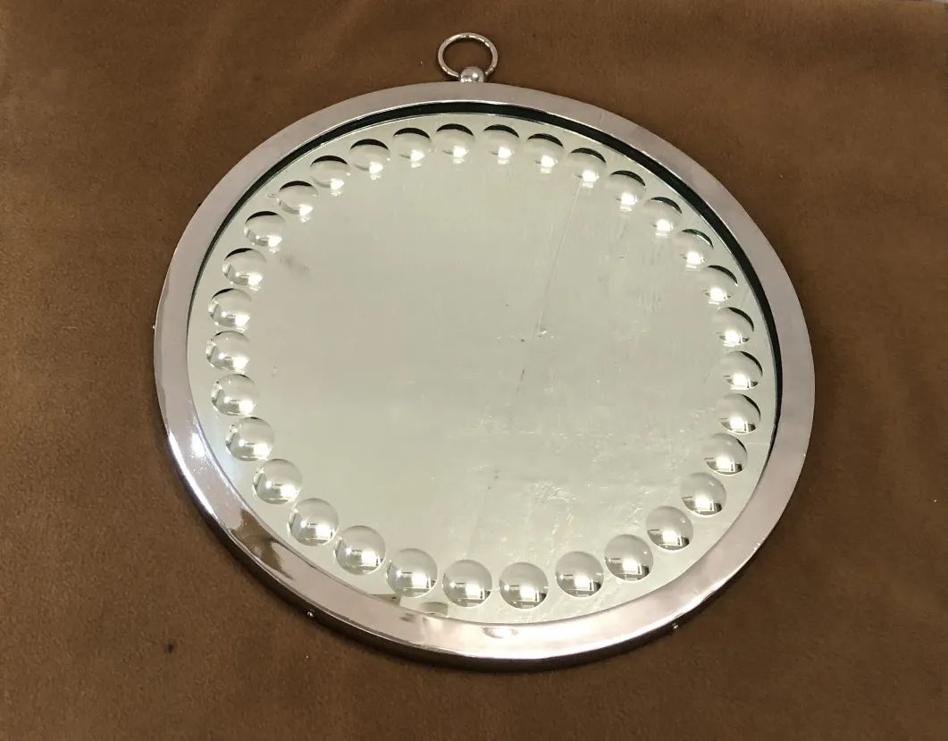 Two antique mirrors with a circular decorative design