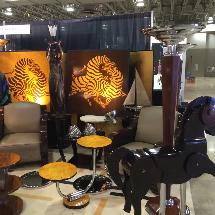 Two antique horses in a decorative display surrounded by other objects