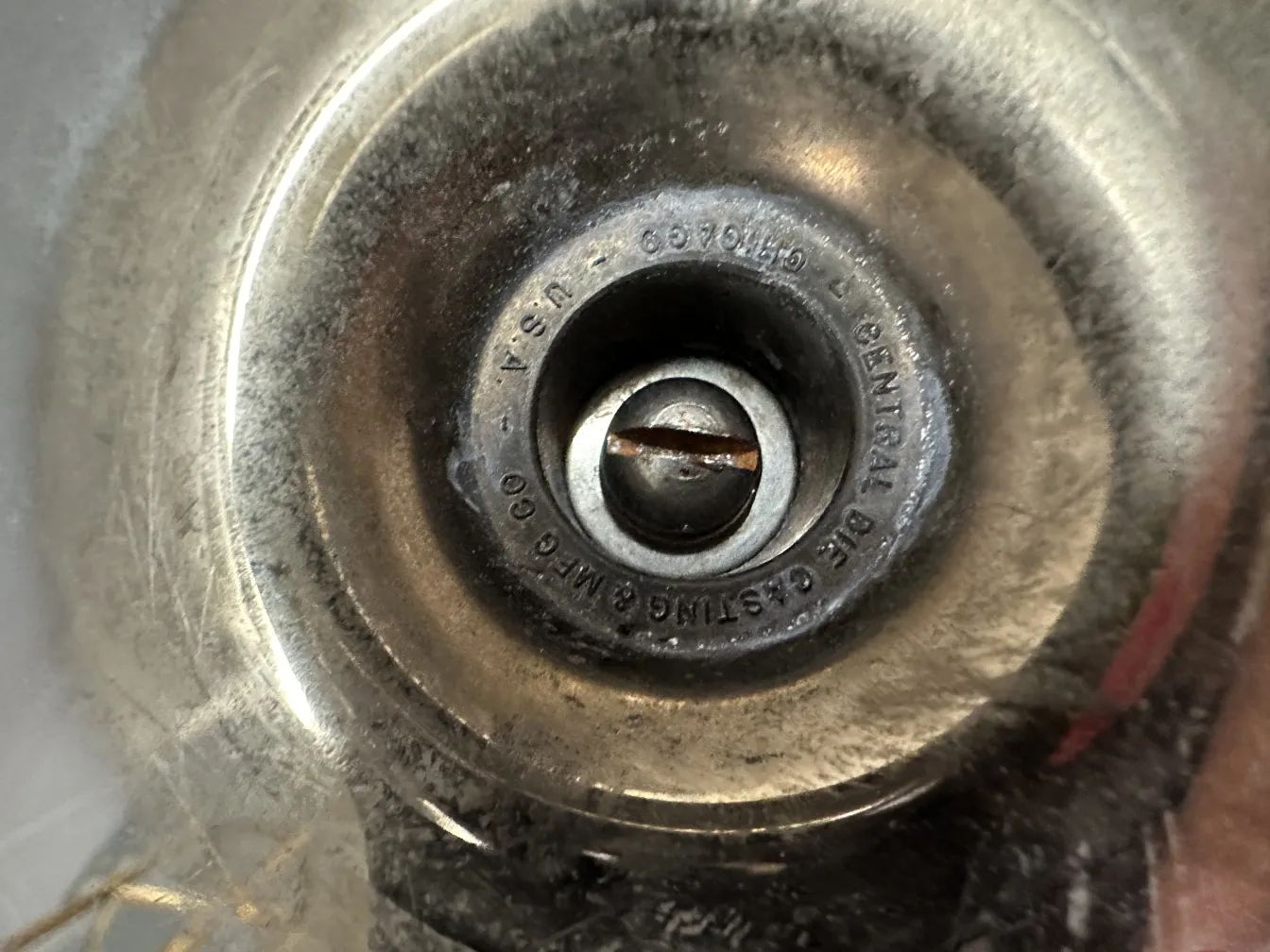 antiker Aschenbecher mit rundem Design und erhabenem Zentrum in einer vernachlässigten Umgebung