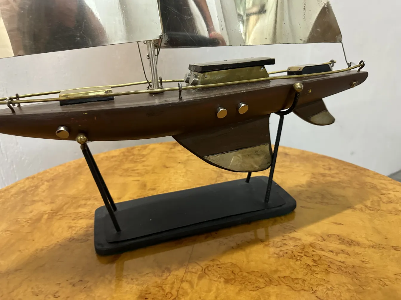 Scale model of an antique designer's ship. Features a sleek hull with sails.