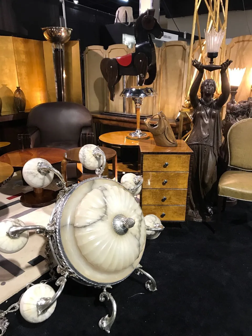 antique wooden horse adorned in a display with furniture