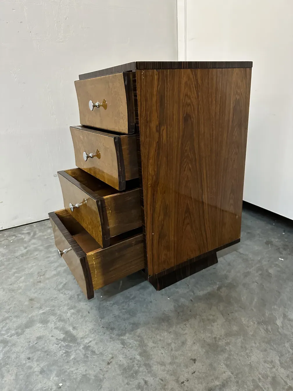 Antique cabinet with attractive handles in a neutral background.