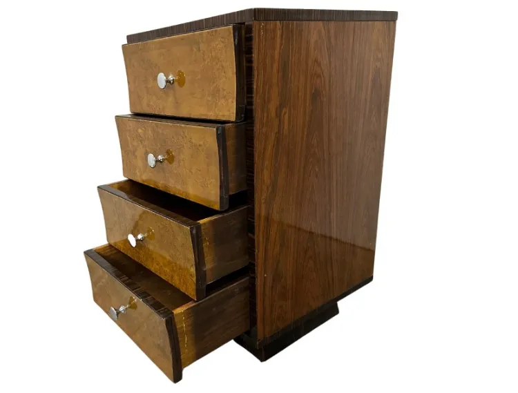 Antique cabinet featuring four drawers with metal handles in a cozy setting.