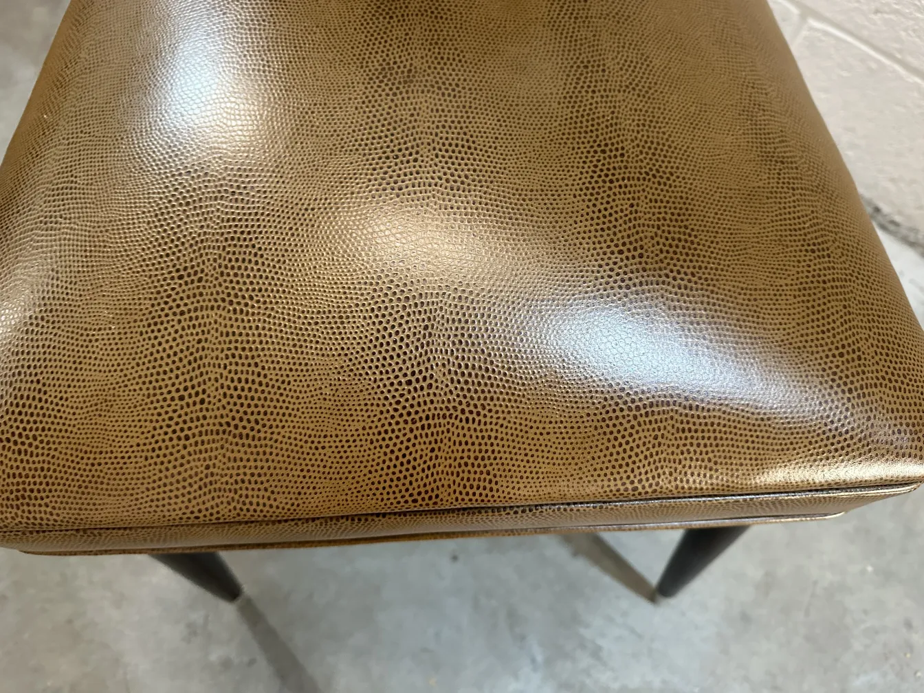 Antique chairs designed by Carlo Mollino, brown color, in a neutral setting.