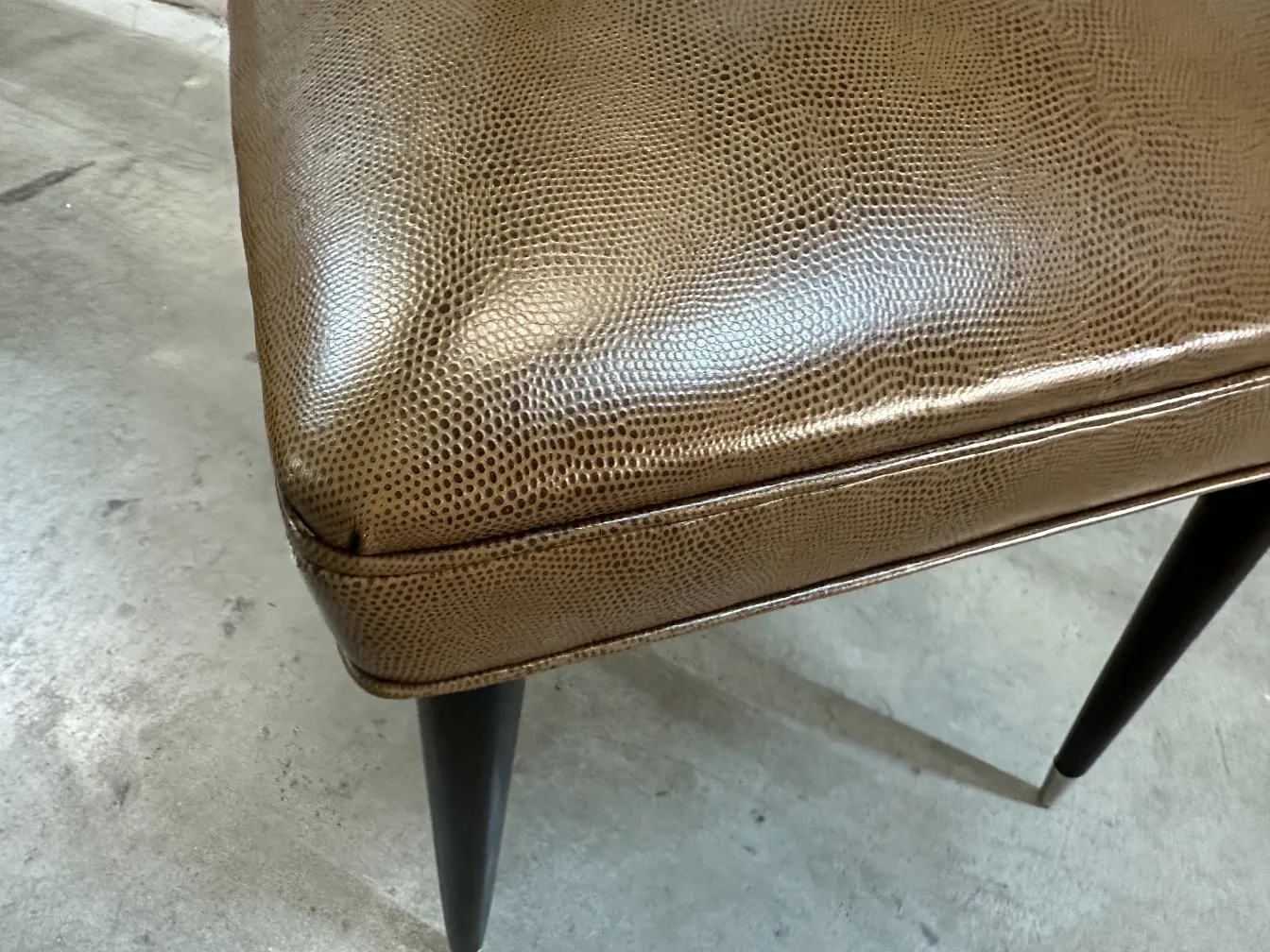 Detalhe de uma cadeira antiga com design elegante e pernas escuras, parte de um conjunto de 12 cadeiras antigas carlo mollino.