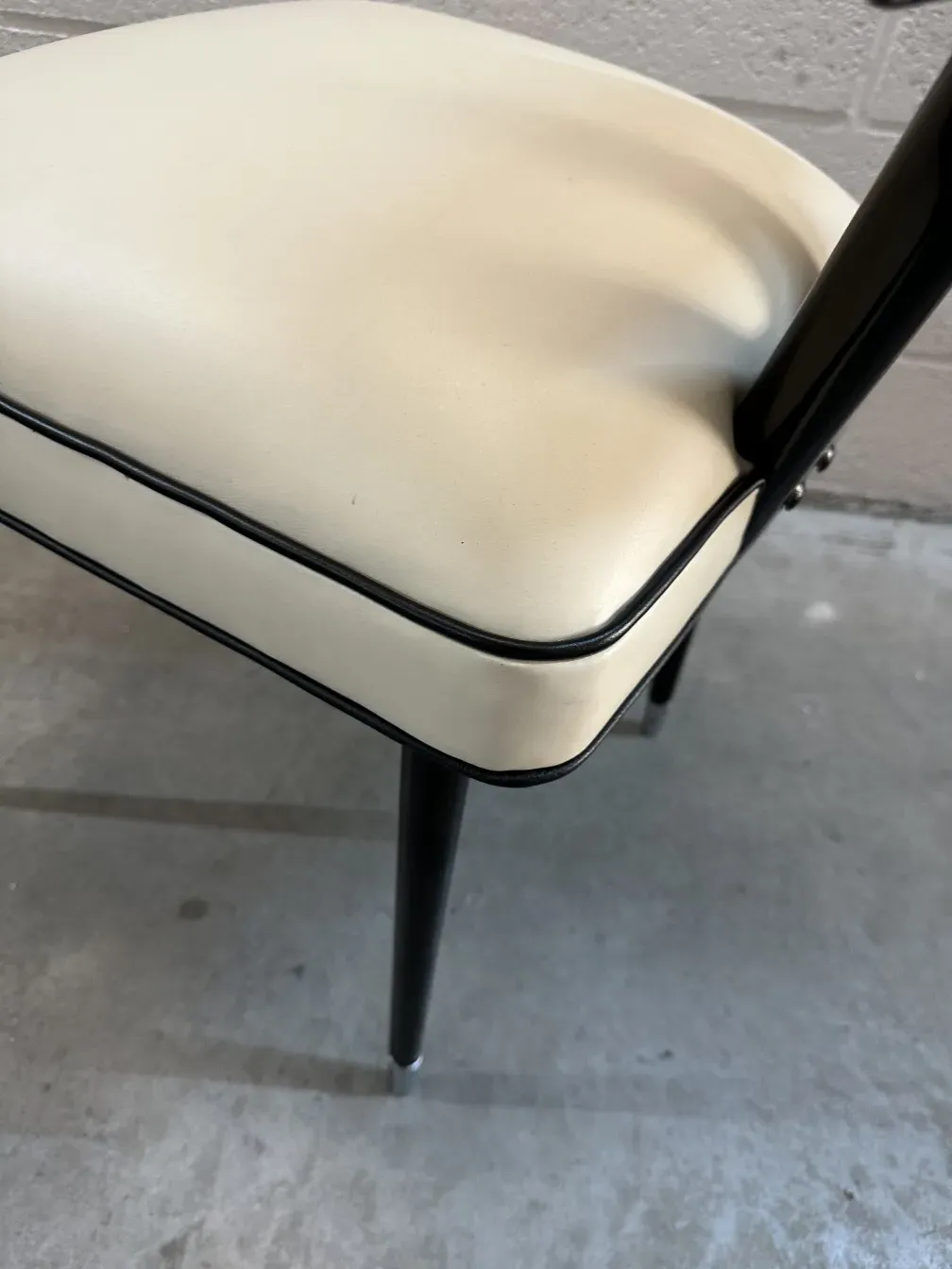 Side view of 2 antique chairs carlo mollino with distinctive finishes