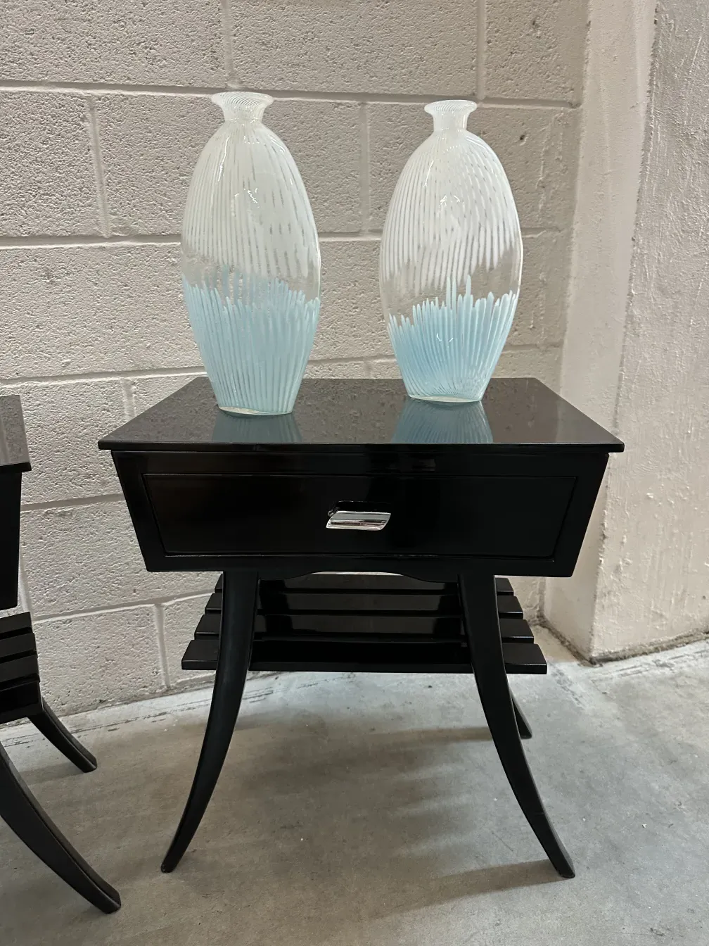 Black antique bedside table with decorative vases