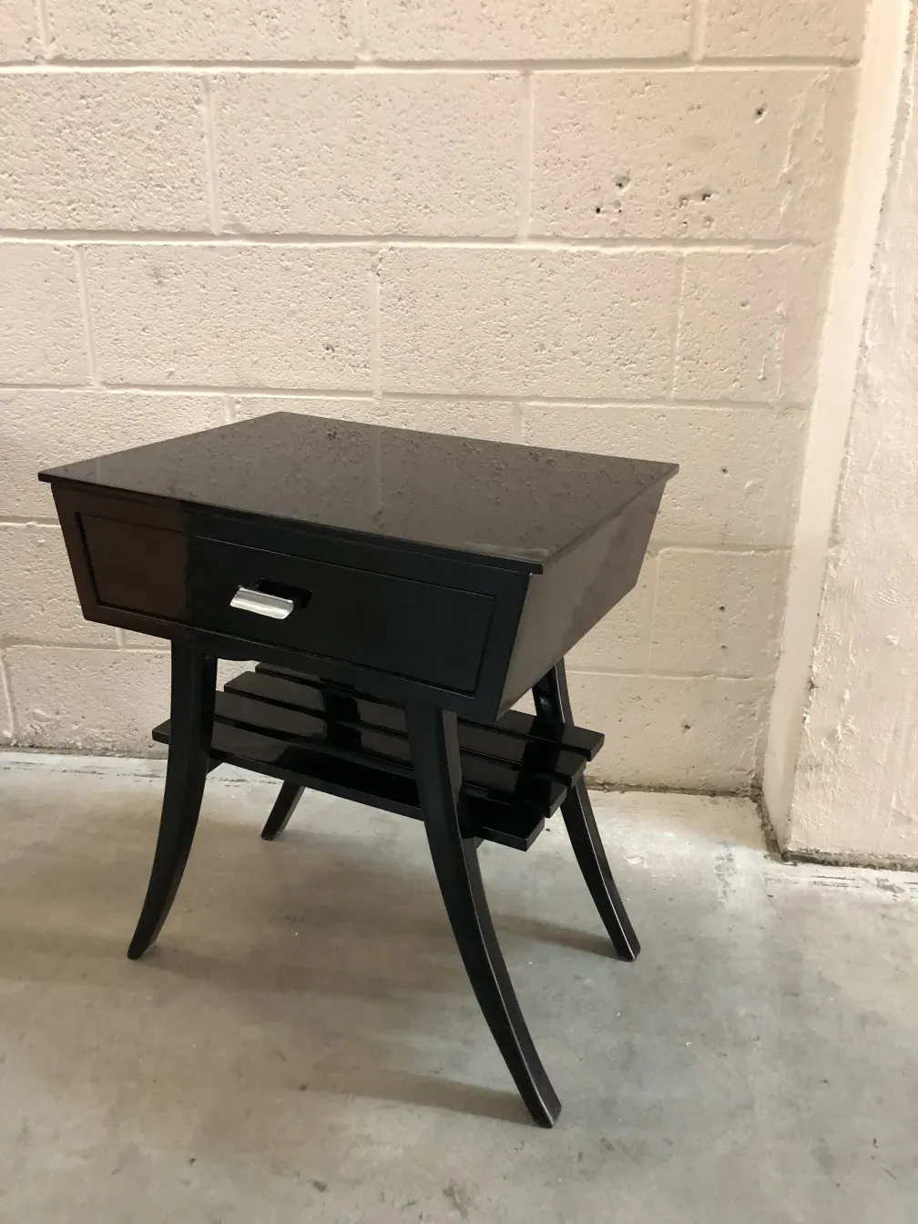 Comodino antico con cassetto e design elegante, ambientato in un contesto minimalista