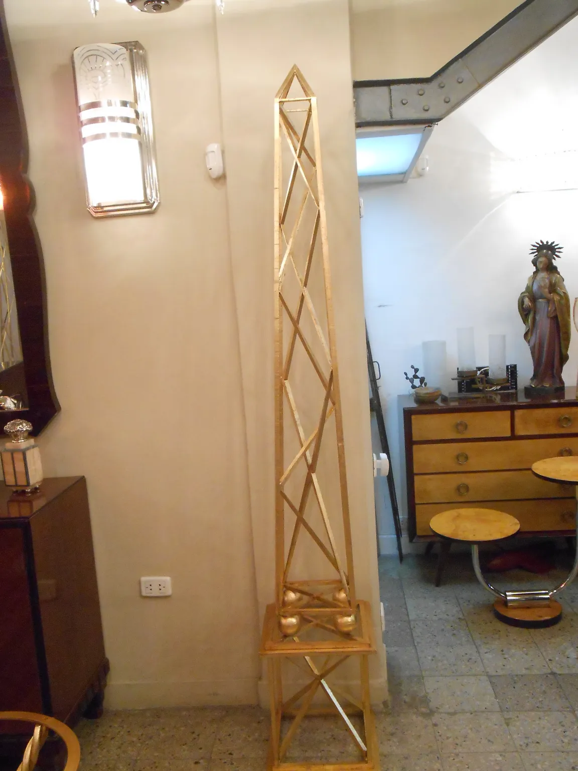 two decorative antique obelisks in a cozy setting