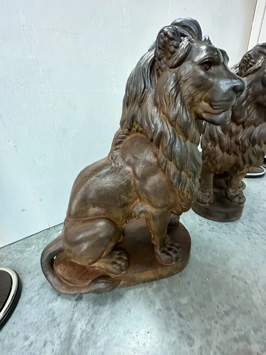 antique sculpture of 2 lions with intricate details
