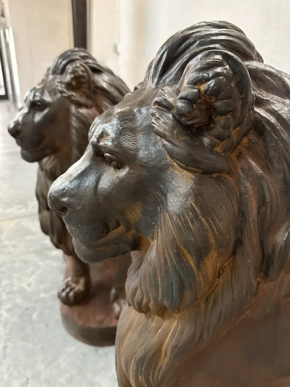 Escultura antigua de dos leones de a. durenner, detalles visibles de los rostros.