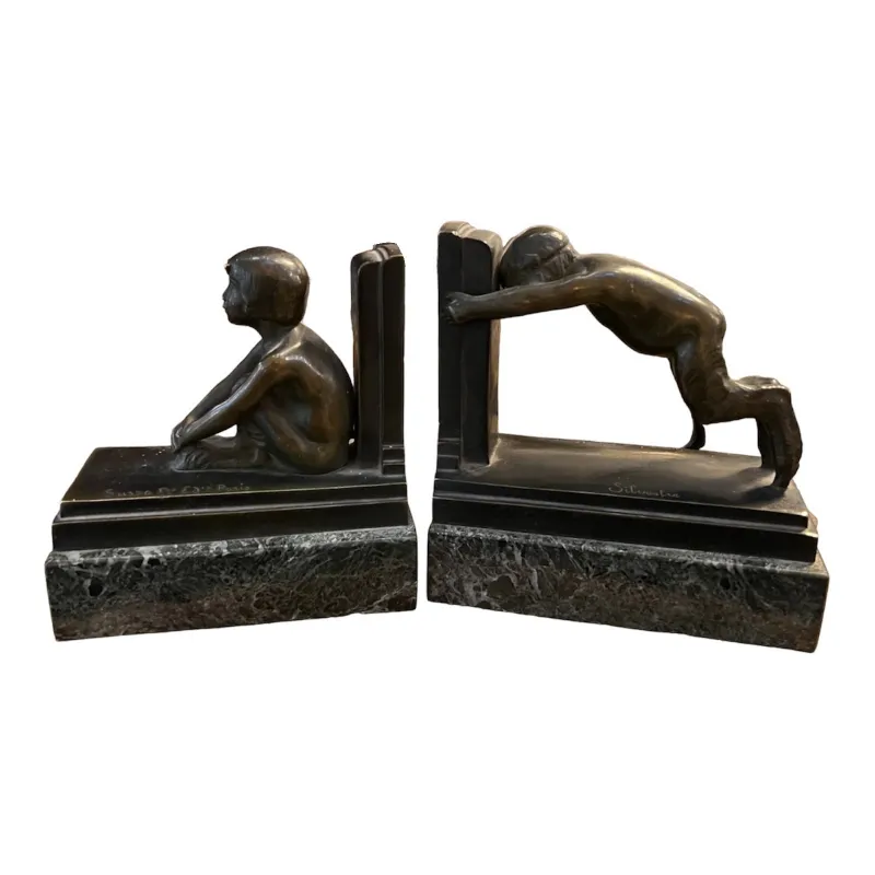 serre-livres anciens de style art déco avec des figures d'enfants