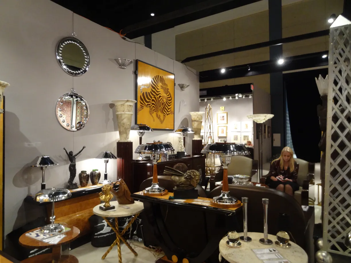 Two antique table lamps in an elegant setting, designed by Jacques Adnet.