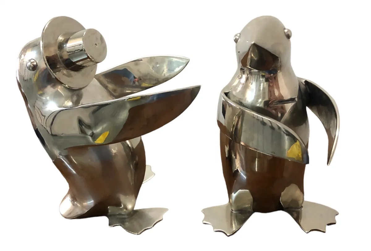two antique penguins in a decorative setting