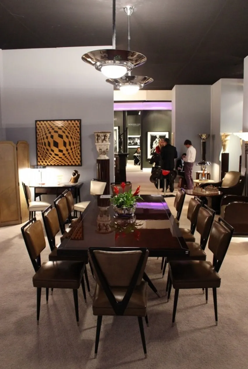 Antique dining table by Carlo Mollino accommodating 10 people in a stylish setting.