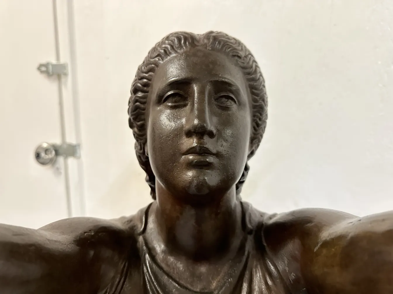 detail of an antique sculpture depicting a human figure