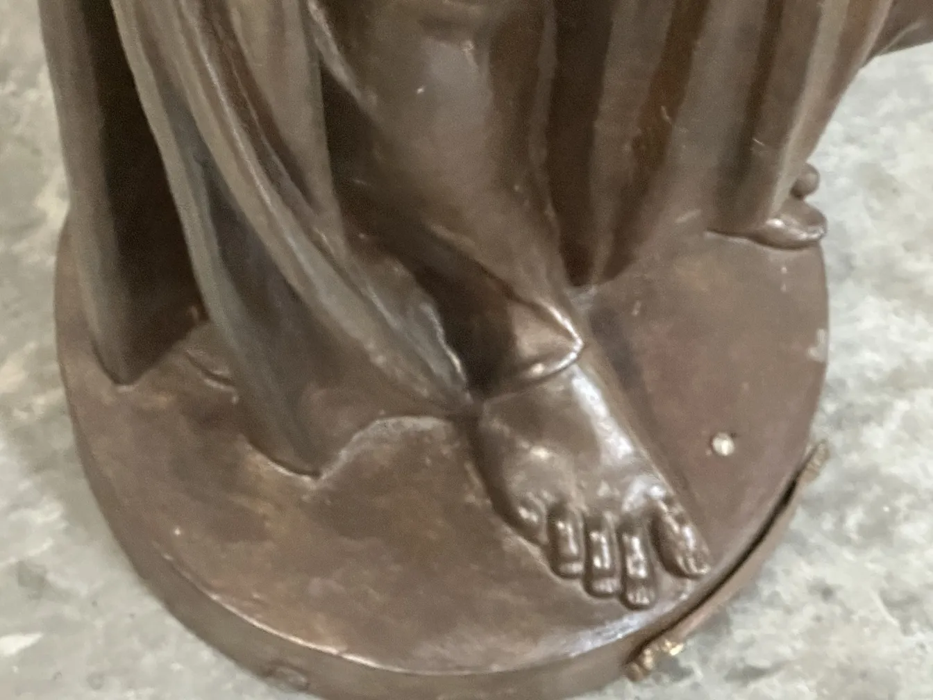 detail of an antique Val D'Osne sculpture with visible foot