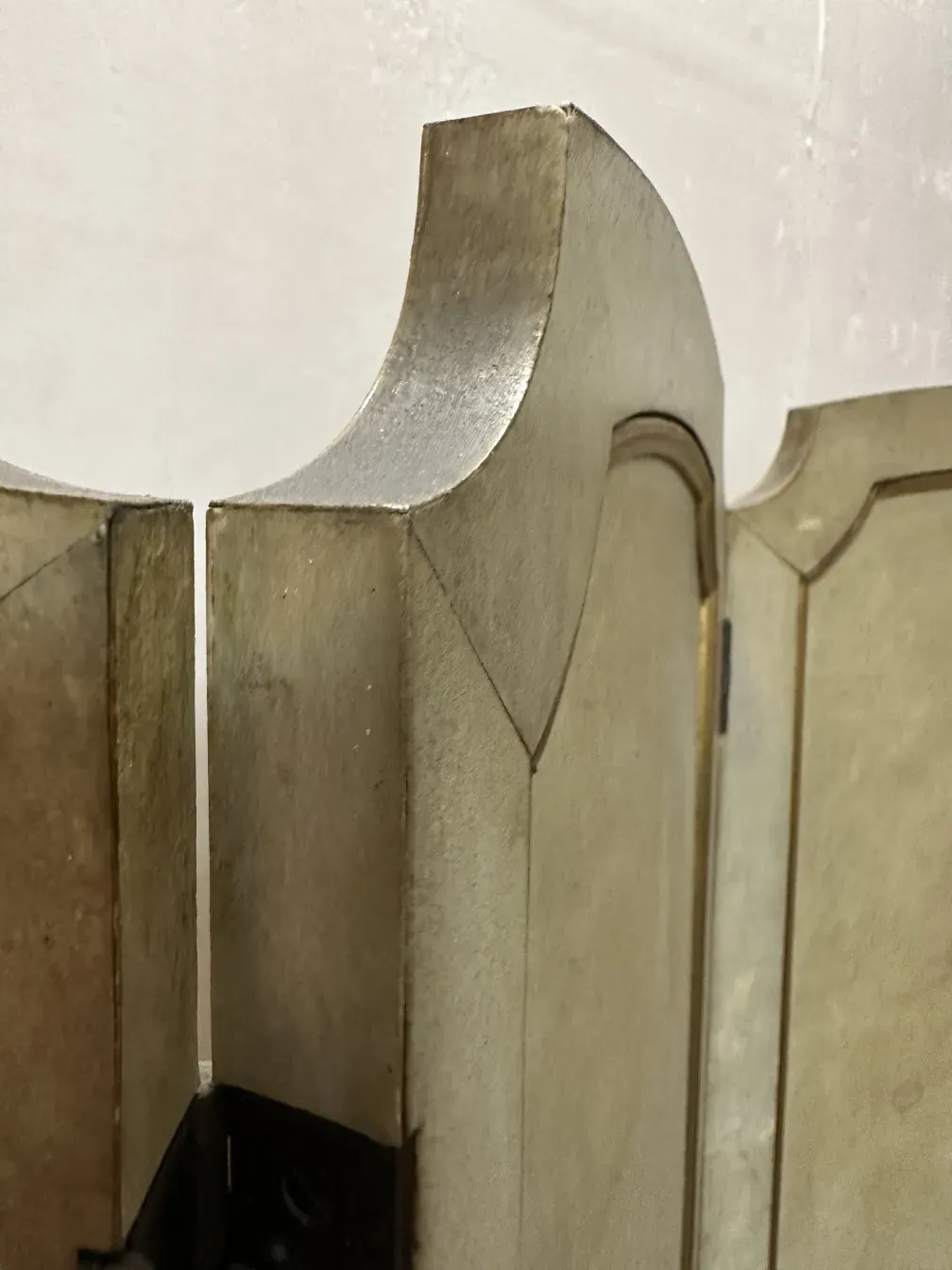 Two antique folding screens featuring unique design in classic setting.