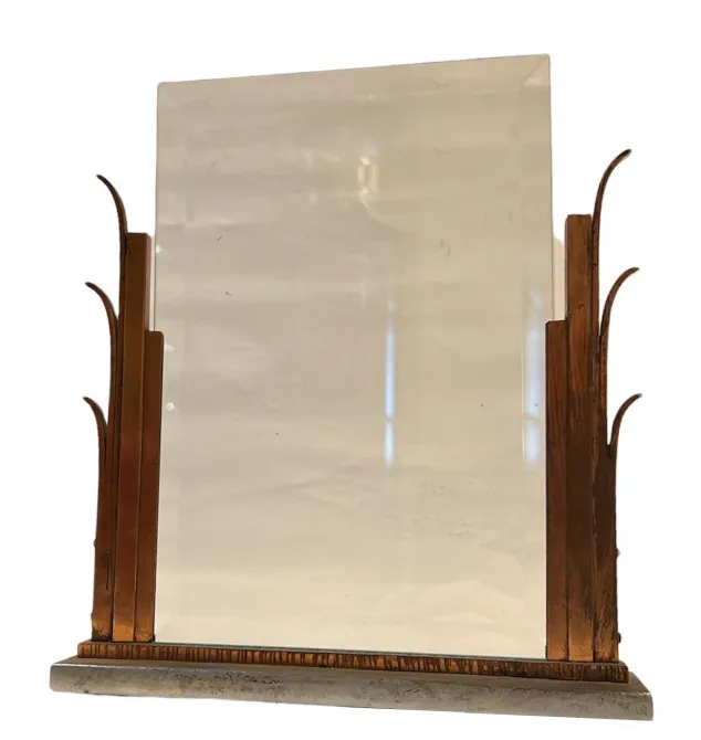 Antique picture frame with decorative base and stylized elements on the edges.