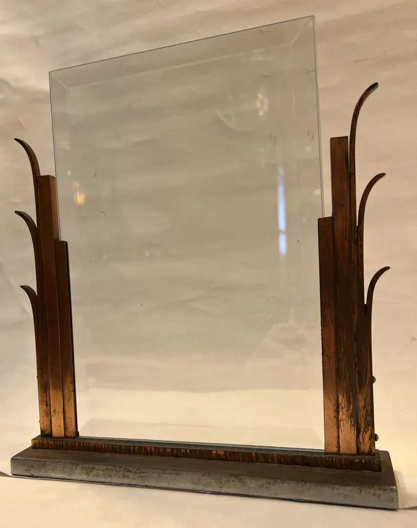 Antique picture frame with decorative structure and space for photos.