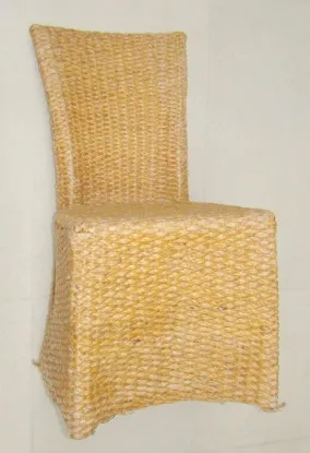 Antique dining table for 4 people in neutral setting.