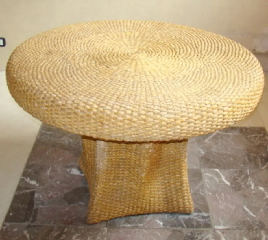 Mesa de jantar antiga com formato redondo e base estruturada, ideal para quatro pessoas.