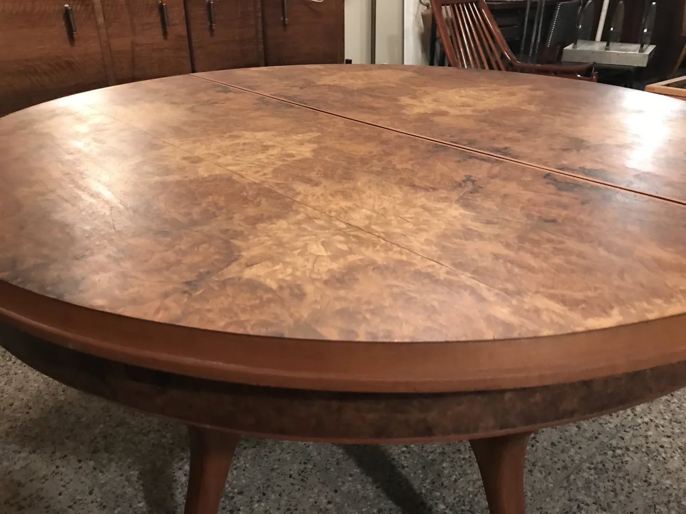 round antique dining table with unique details and a cozy setting.
