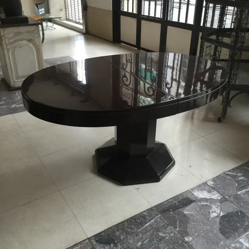 Antique dining table, oval shape, for 6-8 people in an elegant setting.